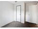 Neutral carpeted bedroom featuring two white paneled doors and minimalist decor at 5045 Se 148Th St, Summerfield, FL 34491