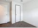 Carpeted bedroom with two white paneled doors at 5045 Se 148Th St, Summerfield, FL 34491