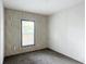 Bright carpeted bedroom featuring a window with blinds and decorative wall paneling at 5045 Se 148Th St, Summerfield, FL 34491