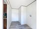 Bright hallway with wood-look vinyl floors, white walls, and convenient laundry hookups at 5045 Se 148Th St, Summerfield, FL 34491