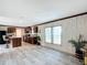 Open-concept kitchen with dark wood cabinets, an island with seating, and black appliances at 5045 Se 148Th St, Summerfield, FL 34491