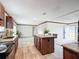 Open kitchen with dark wood cabinets, a central island, and stainless steel appliances at 5045 Se 148Th St, Summerfield, FL 34491