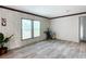 Comfortable living room featuring luxury vinyl plank flooring, fresh neutral paint and plenty of natural light at 5045 Se 148Th St, Summerfield, FL 34491