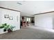 Open concept living room featuring luxury vinyl plank flooring, fresh neutral paint and plenty of natural light at 5045 Se 148Th St, Summerfield, FL 34491