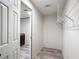 Spacious walk-in closet with wire shelving, complemented by wood-look flooring extending into adjacent bathroom at 5045 Se 148Th St, Summerfield, FL 34491