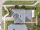 Well-manicured lawn and garden beds add curb appeal to this gray roofed house at 5852 Mariposa Cove Ln, Orlando, FL 32822