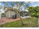 Exterior view of home with a screened in lanai and a well maintained lawn at 5852 Mariposa Cove Ln, Orlando, FL 32822