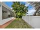 Spacious backyard with a screened in patio and mature landscaping at 5852 Mariposa Cove Ln, Orlando, FL 32822