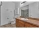 Bathroom with wood cabinets, a large mirror, a vanity, and a stand-up shower at 5852 Mariposa Cove Ln, Orlando, FL 32822