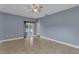 Large bedroom with tile floors, ceiling fan and access to a balcony or patio at 5852 Mariposa Cove Ln, Orlando, FL 32822