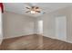 Spacious bedroom featuring wood-look floors, a ceiling fan and a closet at 5852 Mariposa Cove Ln, Orlando, FL 32822