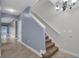 Inviting entryway featuring staircase, neutral paint, tile floors, and stylish chandelier at 5852 Mariposa Cove Ln, Orlando, FL 32822