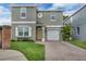 Charming home with a brick-paved driveway, well-maintained lawn, and an attached one-car garage at 5852 Mariposa Cove Ln, Orlando, FL 32822