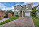 Charming home with a brick-paved driveway, well-maintained lawn, and a brick fence at 5852 Mariposa Cove Ln, Orlando, FL 32822