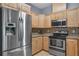 Modern kitchen with stainless steel refrigerator and appliances, granite countertops, and mosaic backsplash at 5852 Mariposa Cove Ln, Orlando, FL 32822