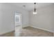 Neutral living area with tile flooring, natural light, and space for furnishings at 5852 Mariposa Cove Ln, Orlando, FL 32822