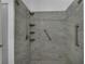 Large walk-in shower featuring gray tile, multiple shower heads and safety bars at 5852 Mariposa Cove Ln, Orlando, FL 32822