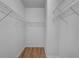 A walk-in closet with wire shelving and light wood floors at 5852 Mariposa Cove Ln, Orlando, FL 32822