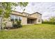 Expansive backyard with lush lawn and a covered patio, perfect for outdoor enjoyment at 619 Oxford Chase Dr, Winter Garden, FL 34787