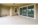 Covered patio with sliding glass doors, with a tranquil view of the backyard at 619 Oxford Chase Dr, Winter Garden, FL 34787