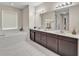 Elegant bathroom with a soaking tub, double vanity, and modern lighting at 619 Oxford Chase Dr, Winter Garden, FL 34787