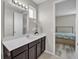 Modern bathroom featuring a vanity with sleek cabinets and a decorative mirror at 619 Oxford Chase Dr, Winter Garden, FL 34787