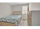 Cozy bedroom showcasing a comfortable bed, wood-look floors, and natural light at 619 Oxford Chase Dr, Winter Garden, FL 34787