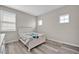 Bedroom featuring a bed with wood trim, wood-look floors, and natural light at 619 Oxford Chase Dr, Winter Garden, FL 34787