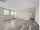 Spacious bonus room features plank flooring, neutral walls, and natural light from multiple windows at 619 Oxford Chase Dr, Winter Garden, FL 34787