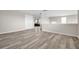 This bonus room is perfect for entertaining or relaxing with luxury plank flooring and neutral decor at 619 Oxford Chase Dr, Winter Garden, FL 34787