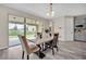 Dining area featuring a modern table and chairs, with access to the backyard through sliding glass doors at 619 Oxford Chase Dr, Winter Garden, FL 34787