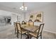 Beautiful dining room with a wooden table, stylish chairs, modern chandelier, and decorative wall art at 619 Oxford Chase Dr, Winter Garden, FL 34787