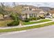 Attractive home featuring manicured landscaping, a neutral color palette, and an attached two car garage at 619 Oxford Chase Dr, Winter Garden, FL 34787