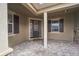 Charming front entrance featuring a stylish door with sidelights and brick-paved patio at 619 Oxford Chase Dr, Winter Garden, FL 34787