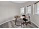 Bright home office boasts natural light from large windows and a stylish L-shaped desk at 619 Oxford Chase Dr, Winter Garden, FL 34787