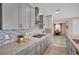 Beautiful kitchen with gray cabinets, stainless steel appliances, granite countertops, and stylish backsplash at 619 Oxford Chase Dr, Winter Garden, FL 34787