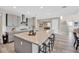 Open-concept kitchen with gray cabinets, a large island with seating, and seamless flow to other living spaces at 619 Oxford Chase Dr, Winter Garden, FL 34787
