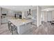 Spacious kitchen features gray cabinetry, stainless steel appliances, granite countertops, and an island with bar seating at 619 Oxford Chase Dr, Winter Garden, FL 34787
