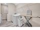 Clean and organized laundry room with washer, dryer, and shelving at 619 Oxford Chase Dr, Winter Garden, FL 34787