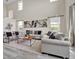 Spacious living room with high ceilings, ample natural light, and contemporary furnishings at 619 Oxford Chase Dr, Winter Garden, FL 34787