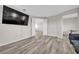Relax in the living room, boasting neutral walls, hardwood floors and a wall-mounted television at 619 Oxford Chase Dr, Winter Garden, FL 34787