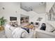 Bright living room featuring soaring ceilings, modern decor, and an open floor plan to the kitchen at 619 Oxford Chase Dr, Winter Garden, FL 34787