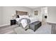 Comfortable main bedroom features a plush bed, soft rug, and bedside lamps at 619 Oxford Chase Dr, Winter Garden, FL 34787