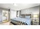 Cozy bedroom with a king bed, closet, en-suite bathroom, and decorative flower wall art at 7219 Oakmoss Loop, Davenport, FL 33837