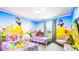 Bright and cheerful bedroom with twin beds and playful Snow White themed decor at 7219 Oakmoss Loop, Davenport, FL 33837
