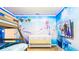 Themed bedroom with bunk bed, crib, mounted television, and 'Frozen' wall decor at 7219 Oakmoss Loop, Davenport, FL 33837
