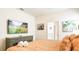 Cozy bedroom with a large television, comfortable bed, and views into the ensuite bathroom at 7219 Oakmoss Loop, Davenport, FL 33837