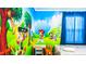 Themed bedroom with one bed, -size table and 'Mickey Mouse' wall decor at 7219 Oakmoss Loop, Davenport, FL 33837