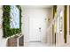 Bright foyer featuring stairs, white door, modern décor, and tiled floors at 7219 Oakmoss Loop, Davenport, FL 33837