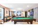 Entertaining game room with a pool table, arcade games, and a Star Wars-themed mural at 7219 Oakmoss Loop, Davenport, FL 33837